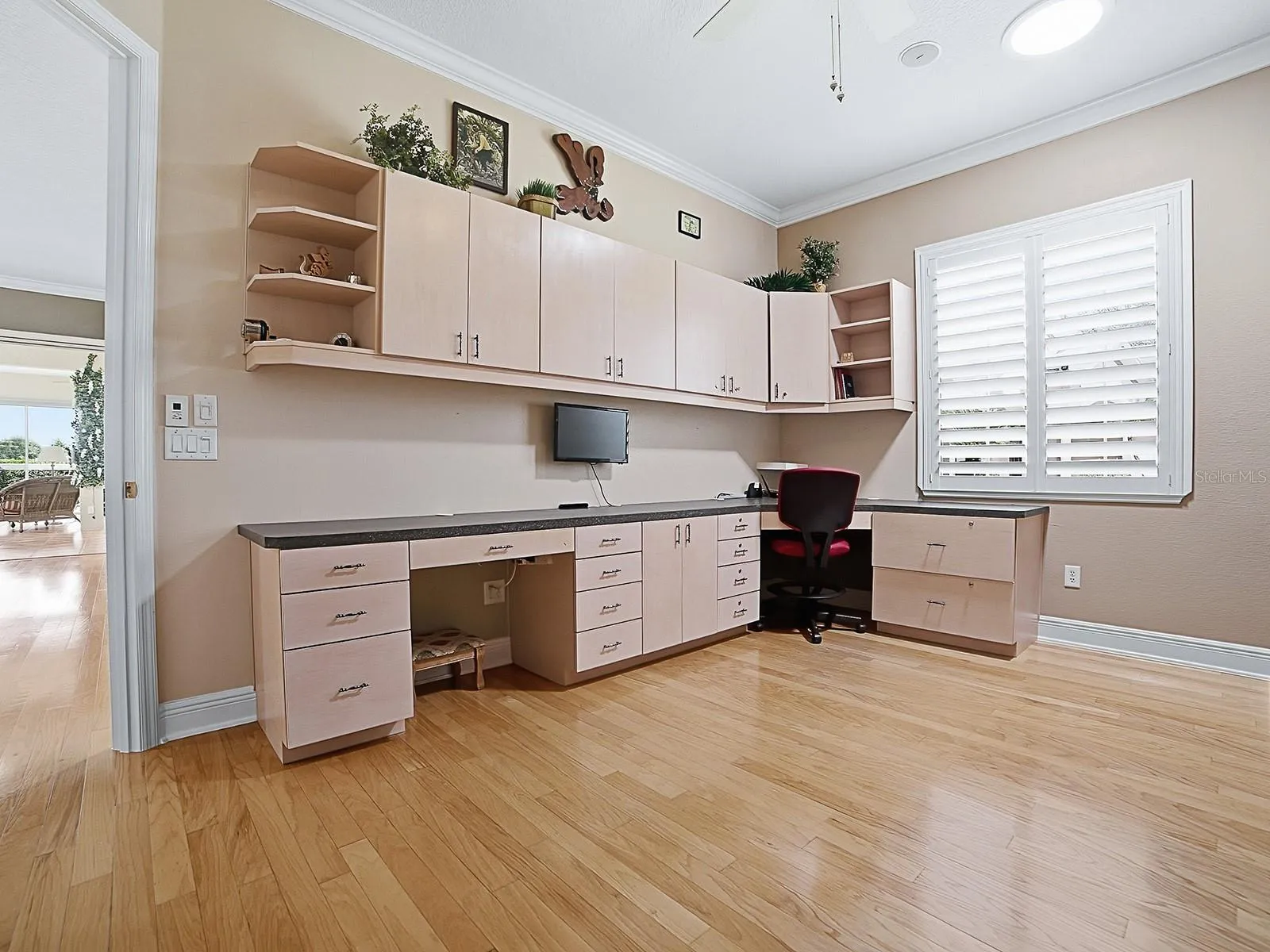 THE 2ND GUEST ROOM HAS A CUSTOM DOOR THAT OPENS OUT TO THE LIVING AREA, A SOLAR TUBE, CUSTOM CABINETS AND BUILT-IN DESK, AND A MURPHY BED.
