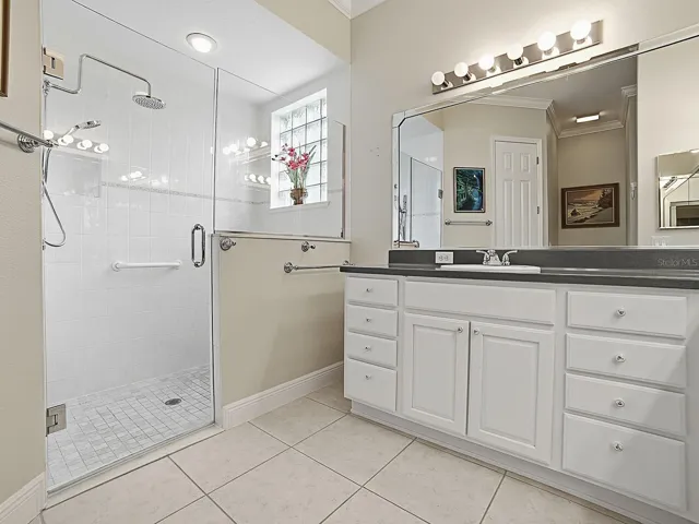 FRAMELESS SHOWER DOOR AND GLASS BLOCK WINDOW FOR NATURAL LIGHTING.