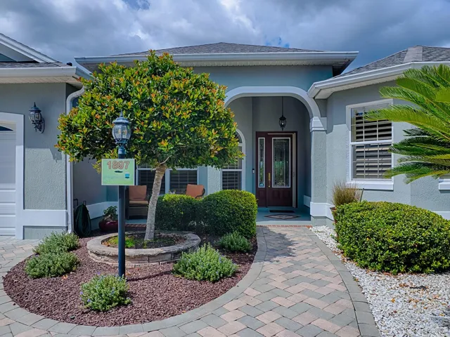LOVELY ENTRANCE WITH A FRONT PORCH AND LEADED GLASS FRONT DOOR WITH SIDELITE.