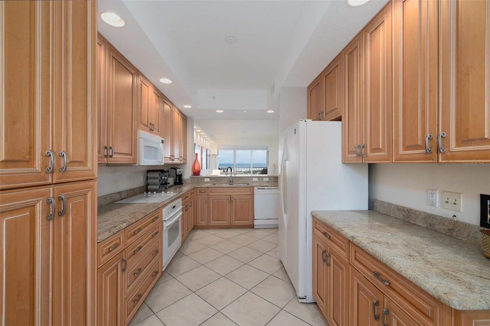 Gourmet kitchen boasts lots of wood cabinets, drawers, & granite counters.