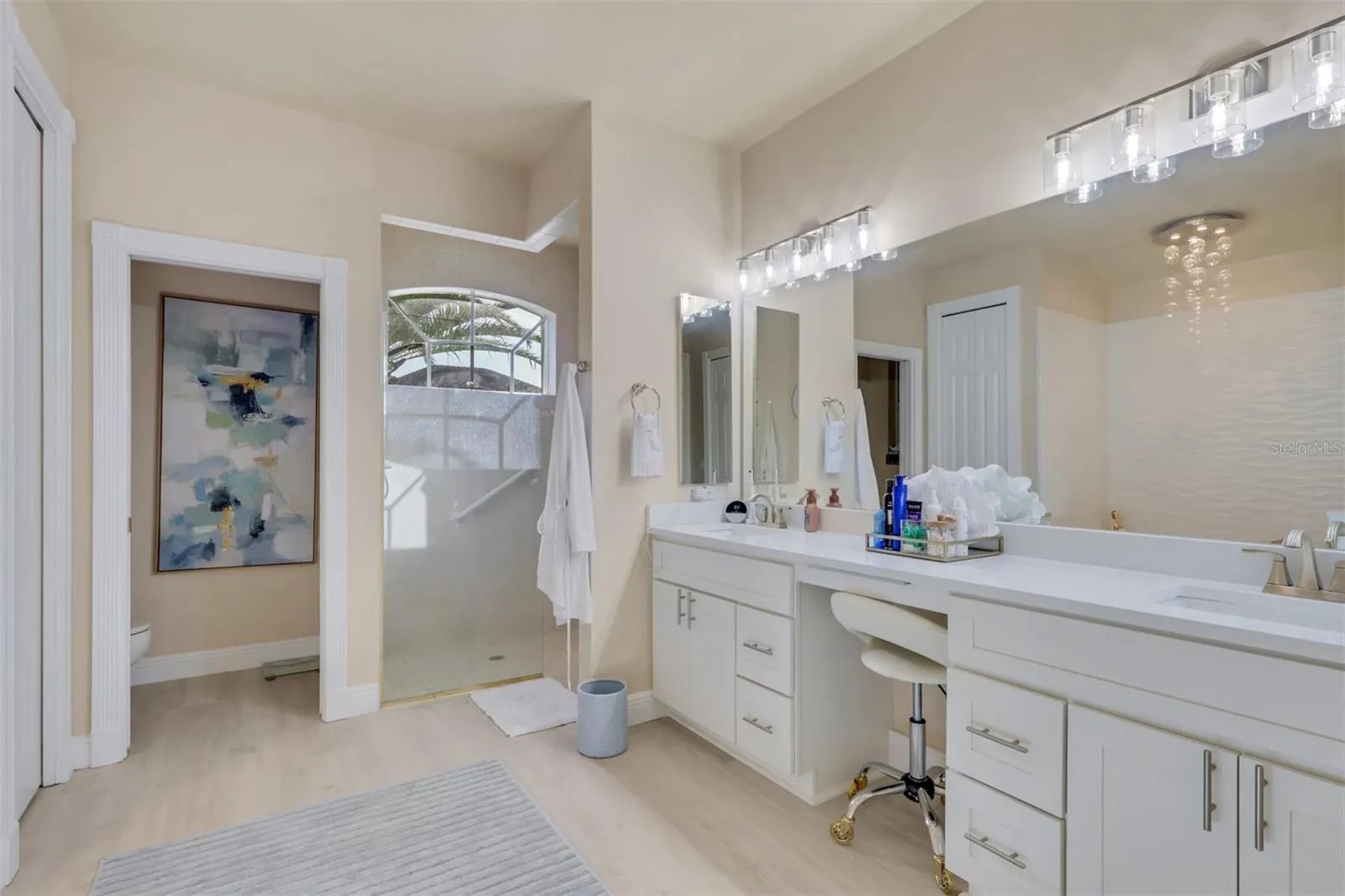 Primary Bathroom with dual vanities and makeup area