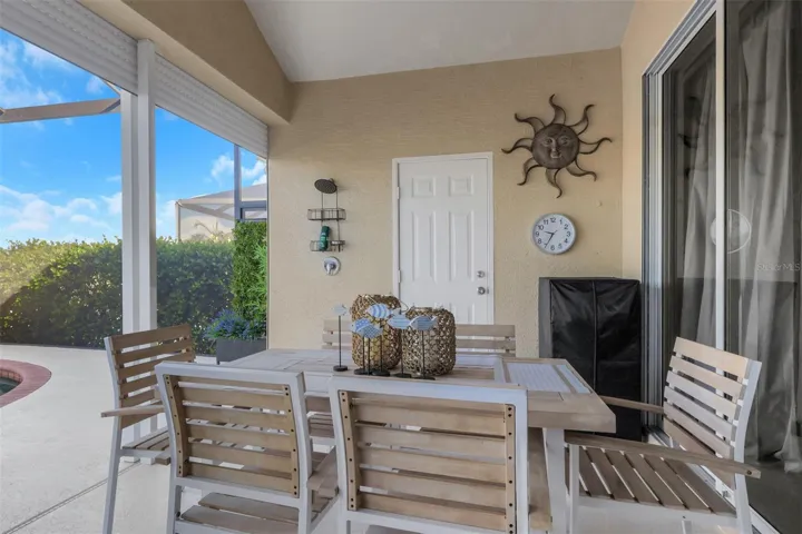 Dining area on lanai overlooking pool and lake