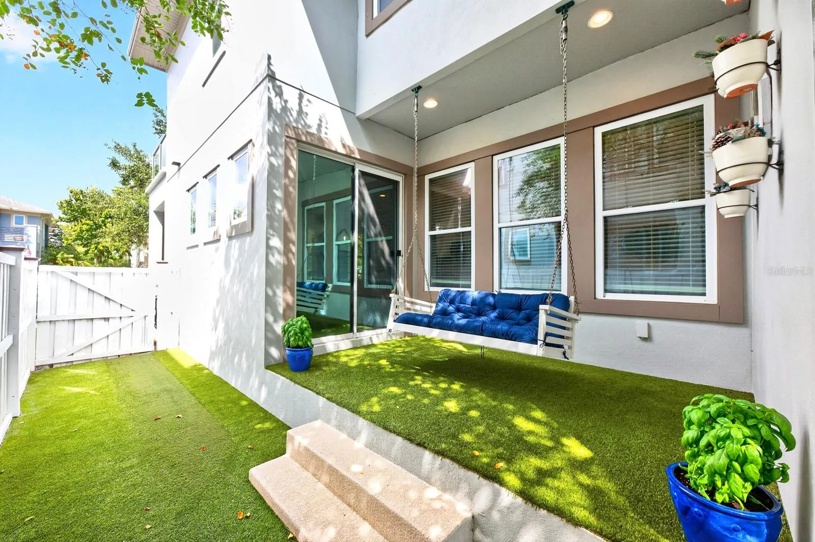 Low maintenance patio, privacy fenced sideyard finished with turf.