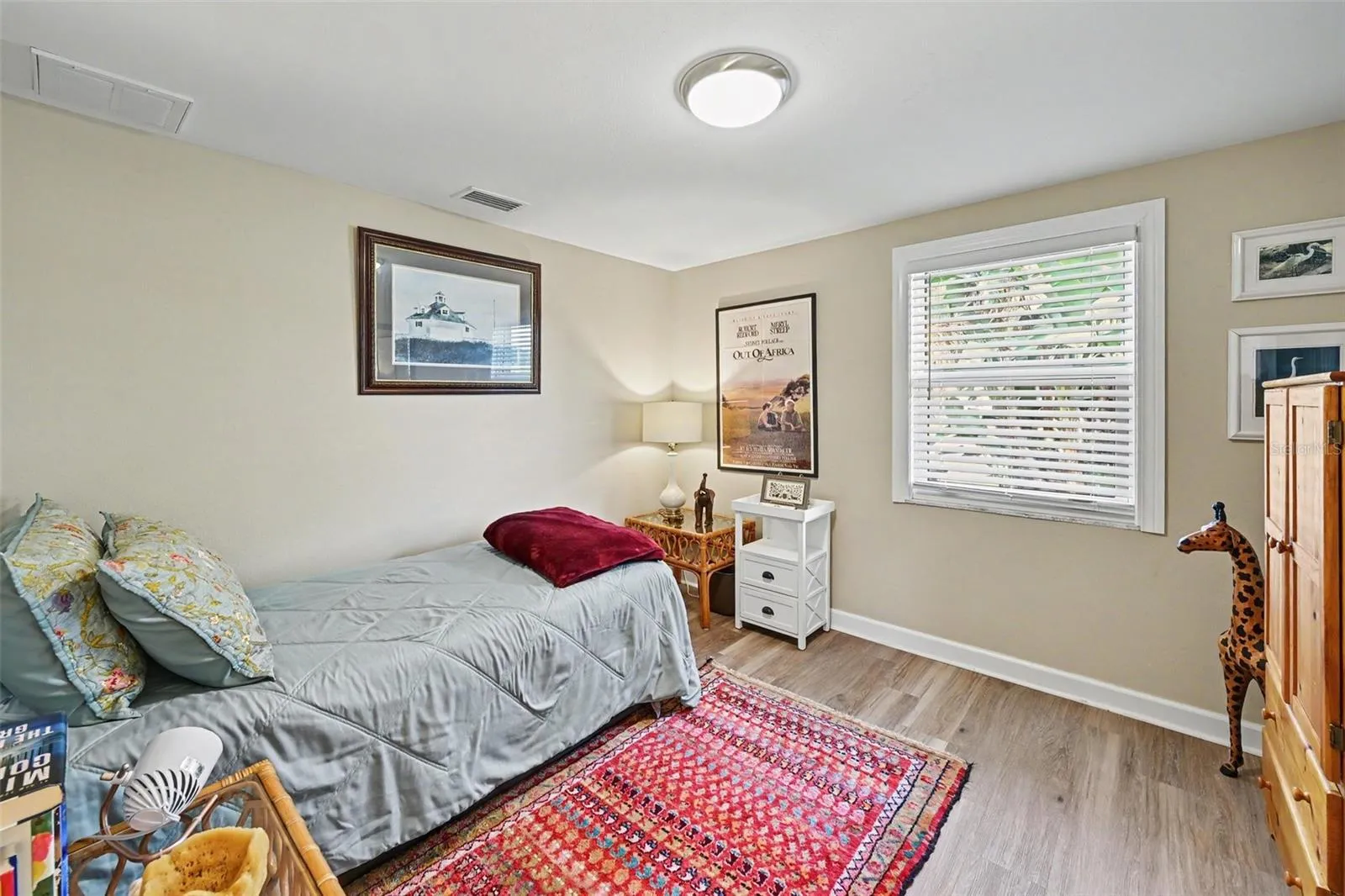 Comfortable guest bedroom featuring a ceiling fan, two windows, and ample space for multiple beds at 412 Redwood Road, Venice, Florida