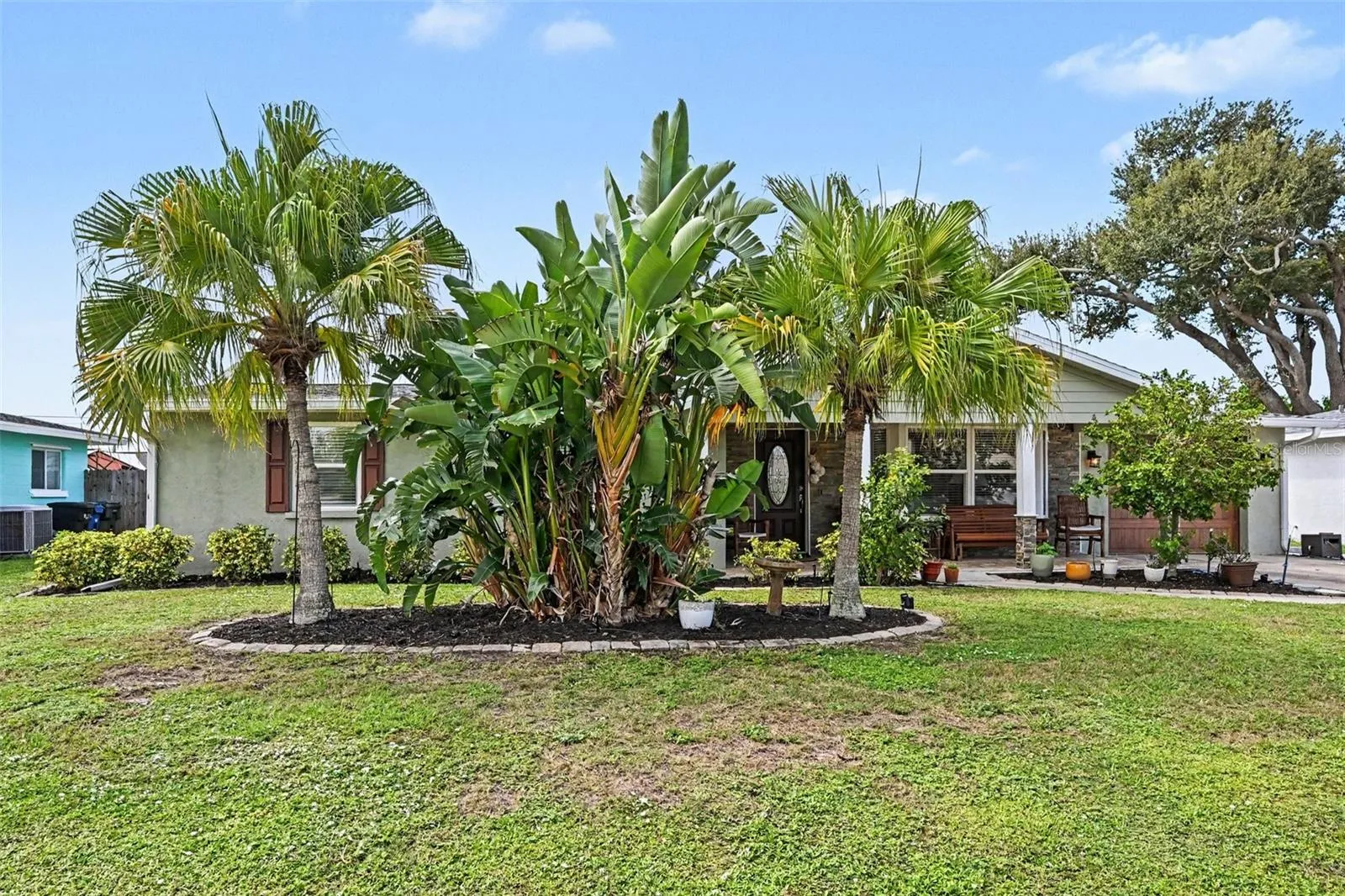 Lush tropical landscaping at the front entry of 412 Redwood Road in Venice, Florida.