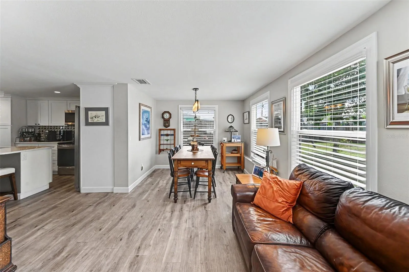 Dining area with large windows seamlessly integrated into the open floor plan at 412 Redwood Road, Venice, Florida