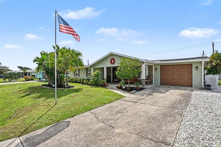 Concrete driveway leading to the attached garage at 412 Redwood Road, Venice, Florida