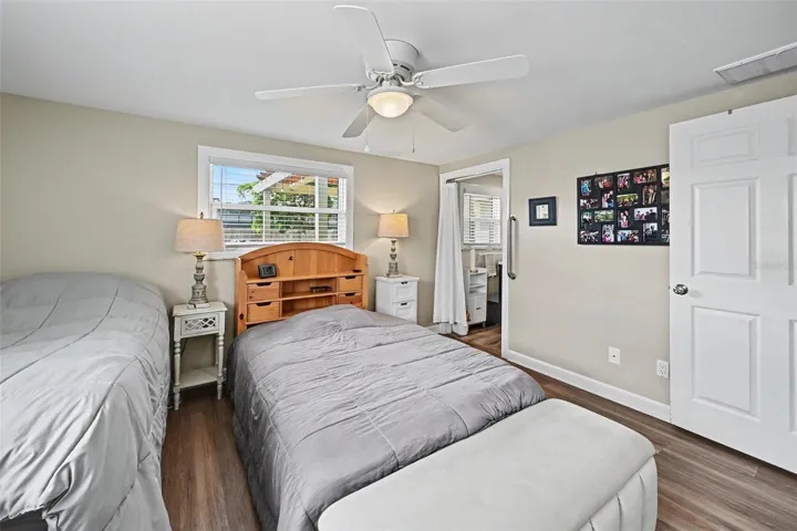 Primary bedroom showing closet space and direct access to an adjacent bathroom at 412 Redwood Road, Venice, Florida