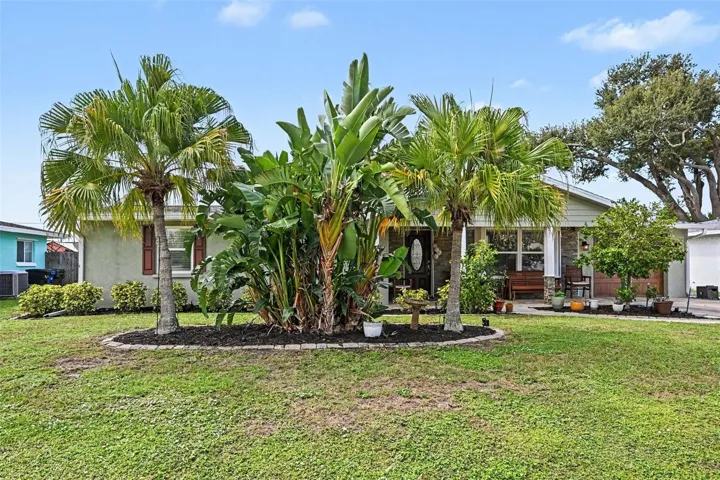 Lush tropical landscaping at the front entry of 412 Redwood Road in Venice, Florida.