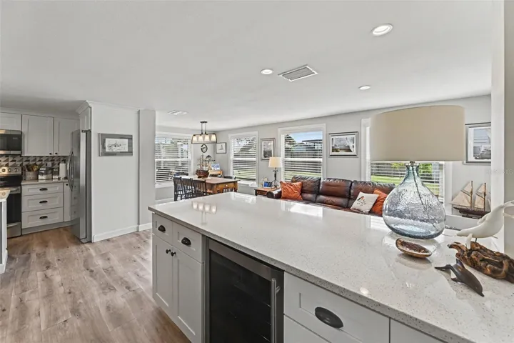 Wine cooler island featuring a quartz island, wine cooler at 412 Redwood Road, Venice, Florida