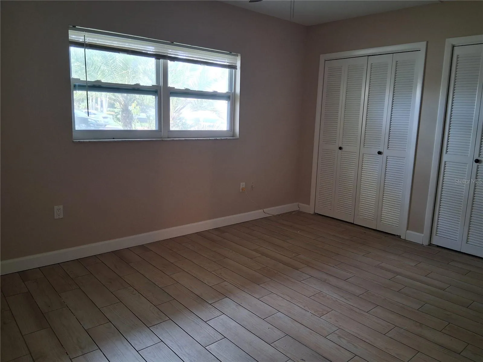 large bedroom with double closet and new windows