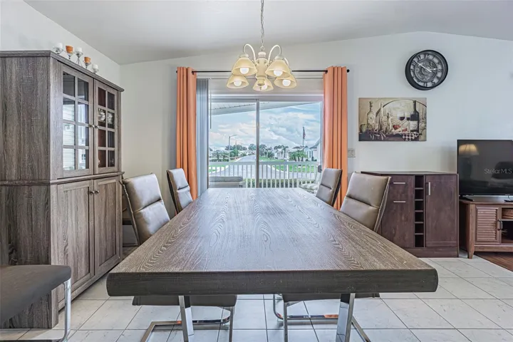 Large dining space OPEN to living room and kitchen, with sunny Florida sky views!