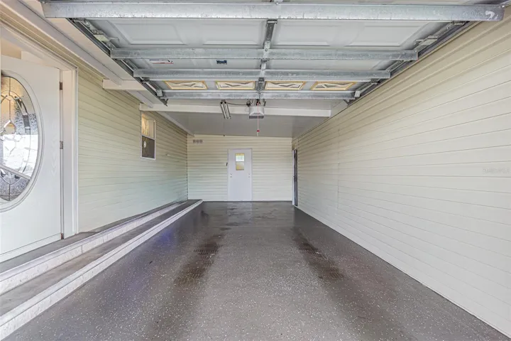 One car garage with epoxy floor finish and shed access