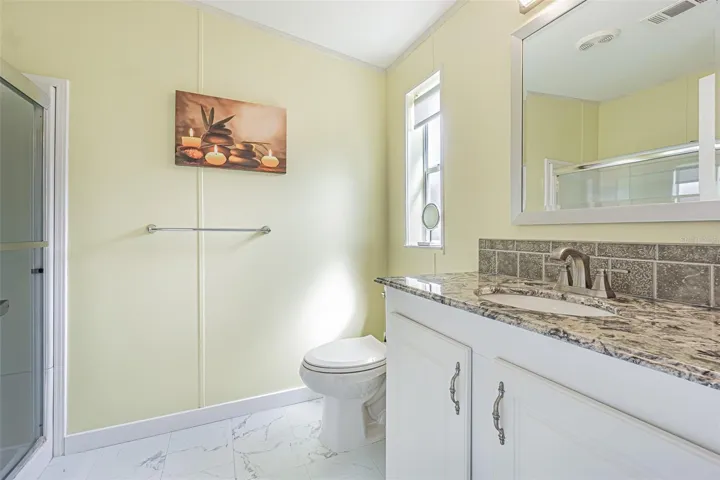 Granite countertops and updated floors in this sleek bath