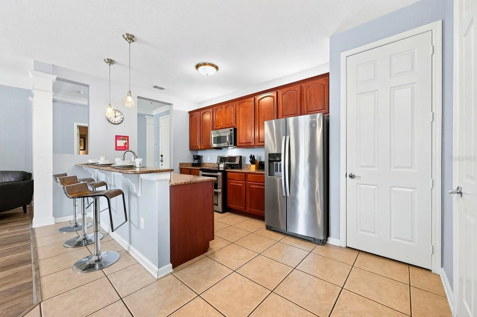 The well-appointed kitchen offers STAINLESS STEEL APPLIANCES, generous cabinet and counter space, a pantry and BREAKFAST BAR for casual dining.