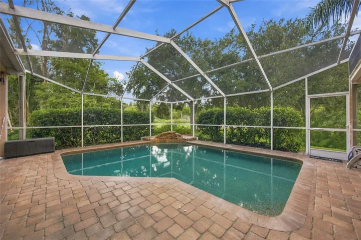 Pool with enclosure and paved patio