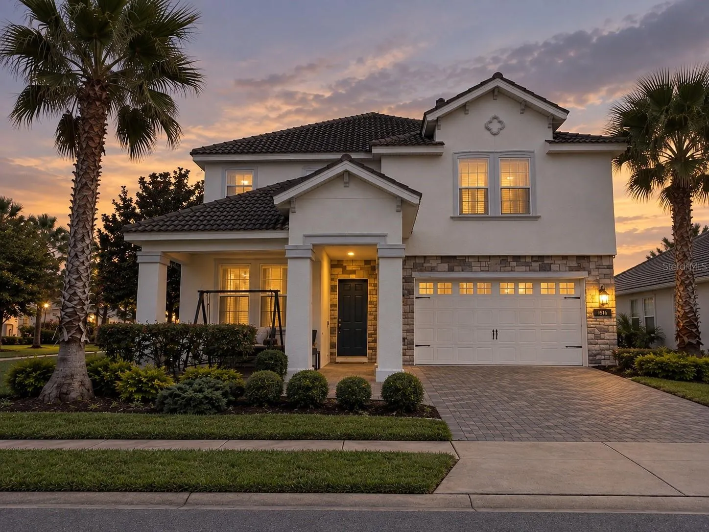Twilight view highlighting the home's welcoming exterior and architectural details.