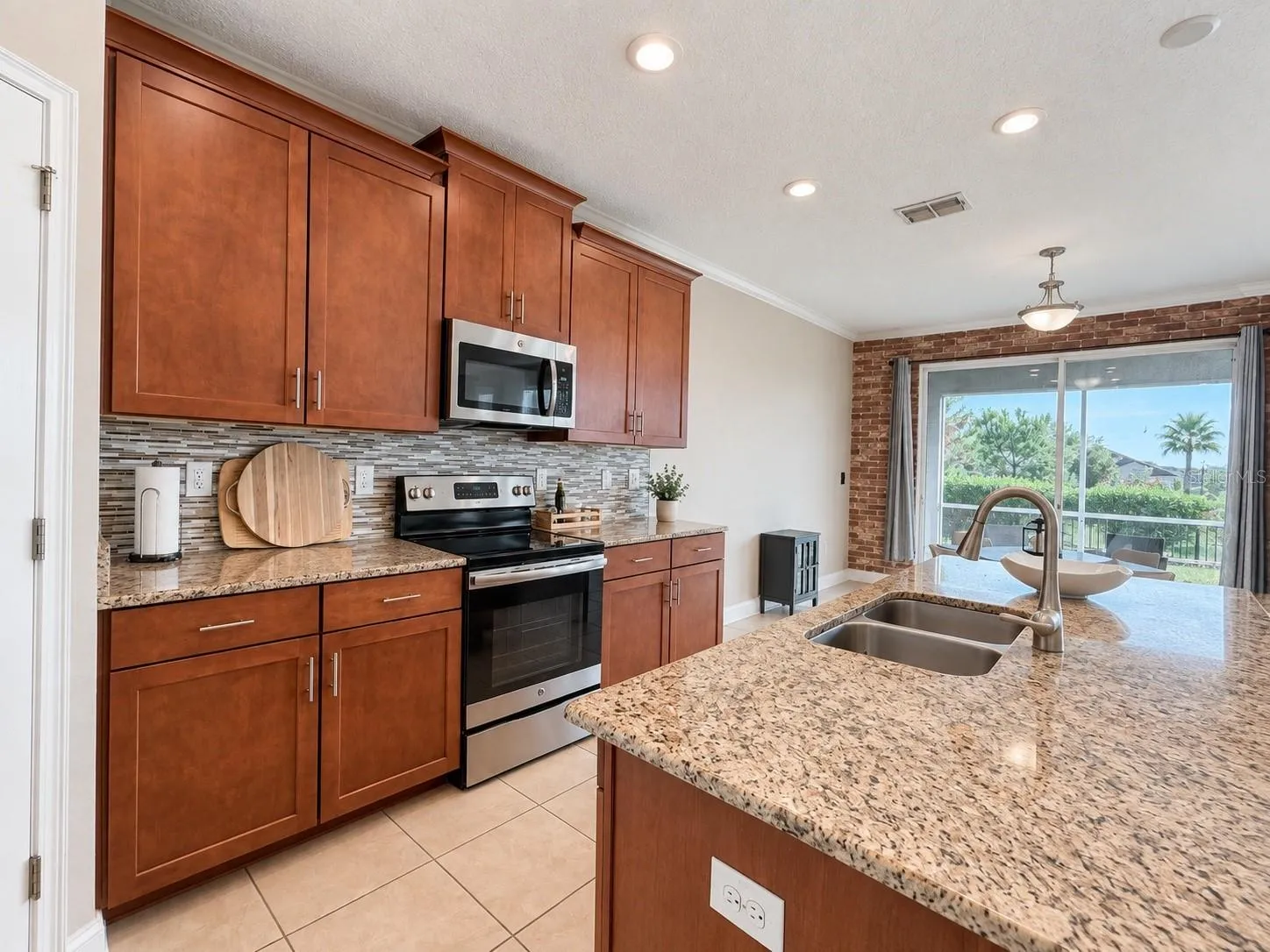 Spacious kitchen with abundant cabinetry, generous counter space and an open connection to the main living area.