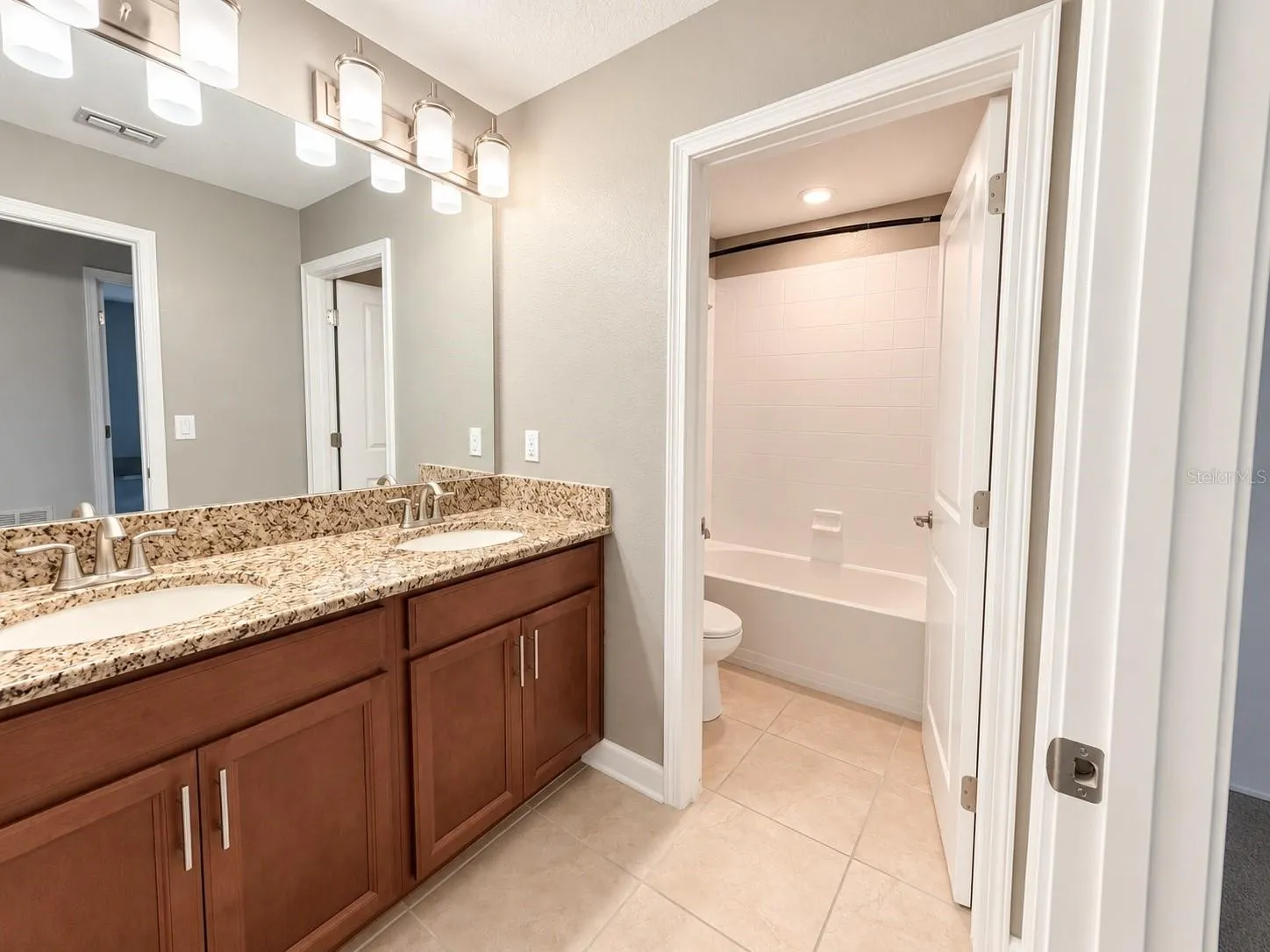 Well-appointed secondary bathroom conveniently located for bedrooms and guests.