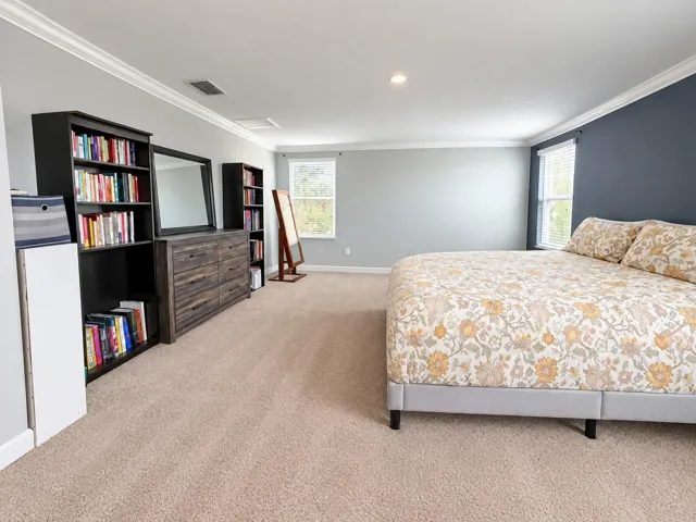 Spacious primary bedroom featuring abundant natural light and a large walk-in  his and hers closet.