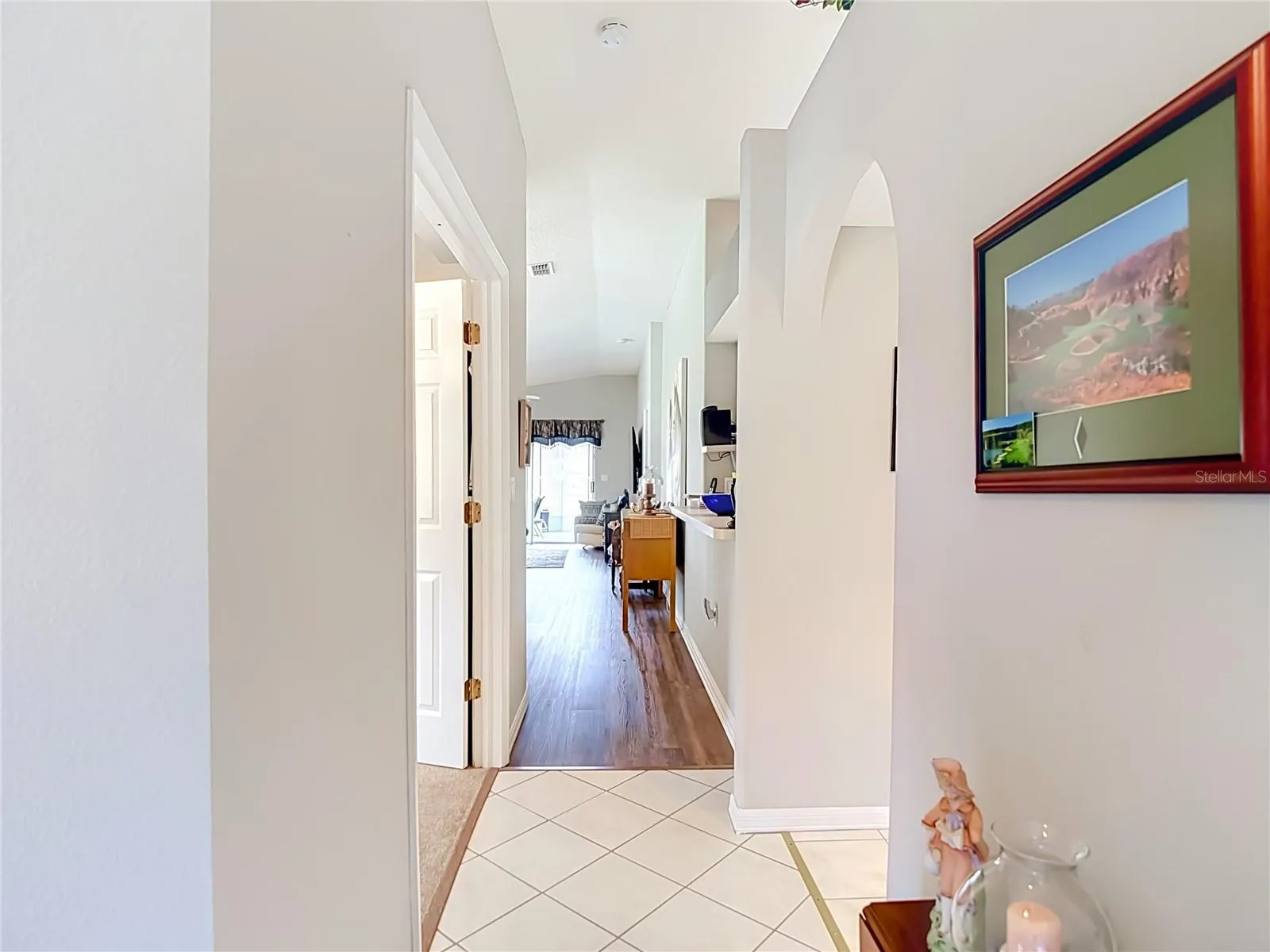 You enter home on a ceramic tile floor. The kitchn is to the right and bedroom 2 is to your left.