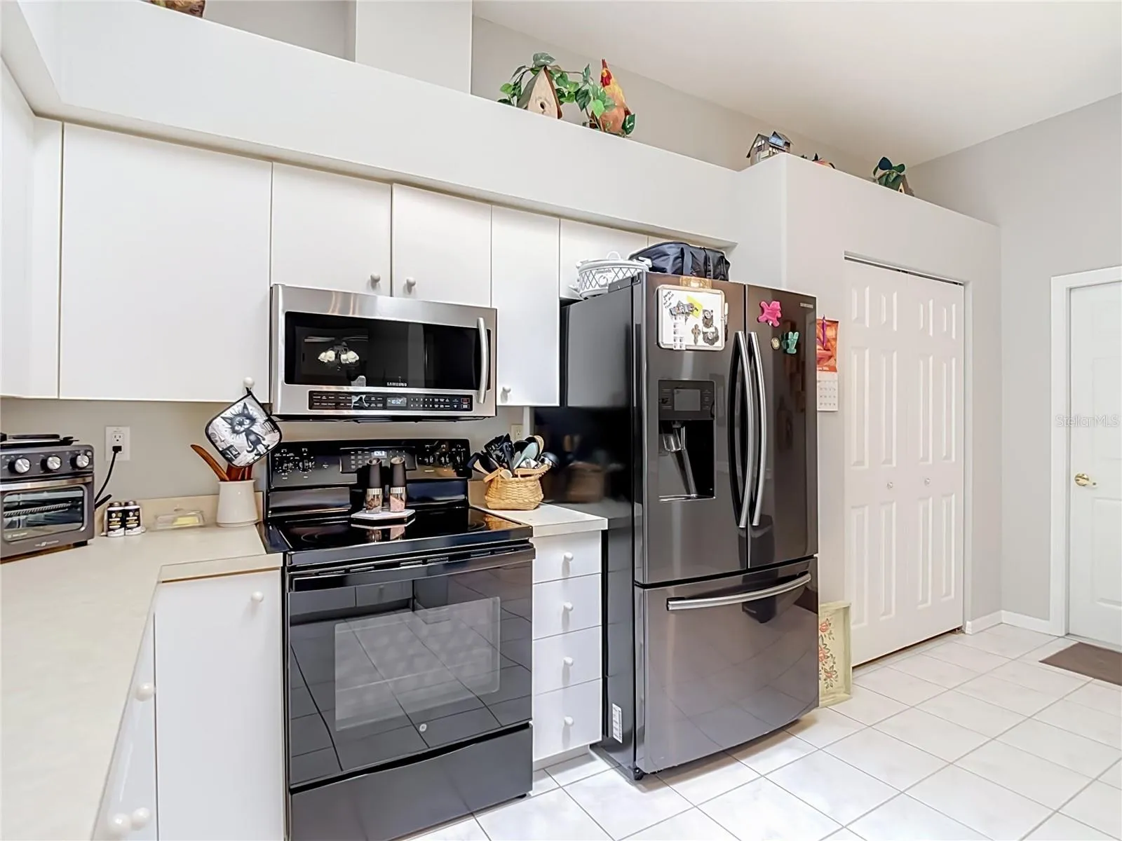 Kitche has newer appliances with a double door refrigerator and drawer freezer along with range and microwave. The door the right of refrigerator is a closet pantry for your groceries. The other door opens into the garage.