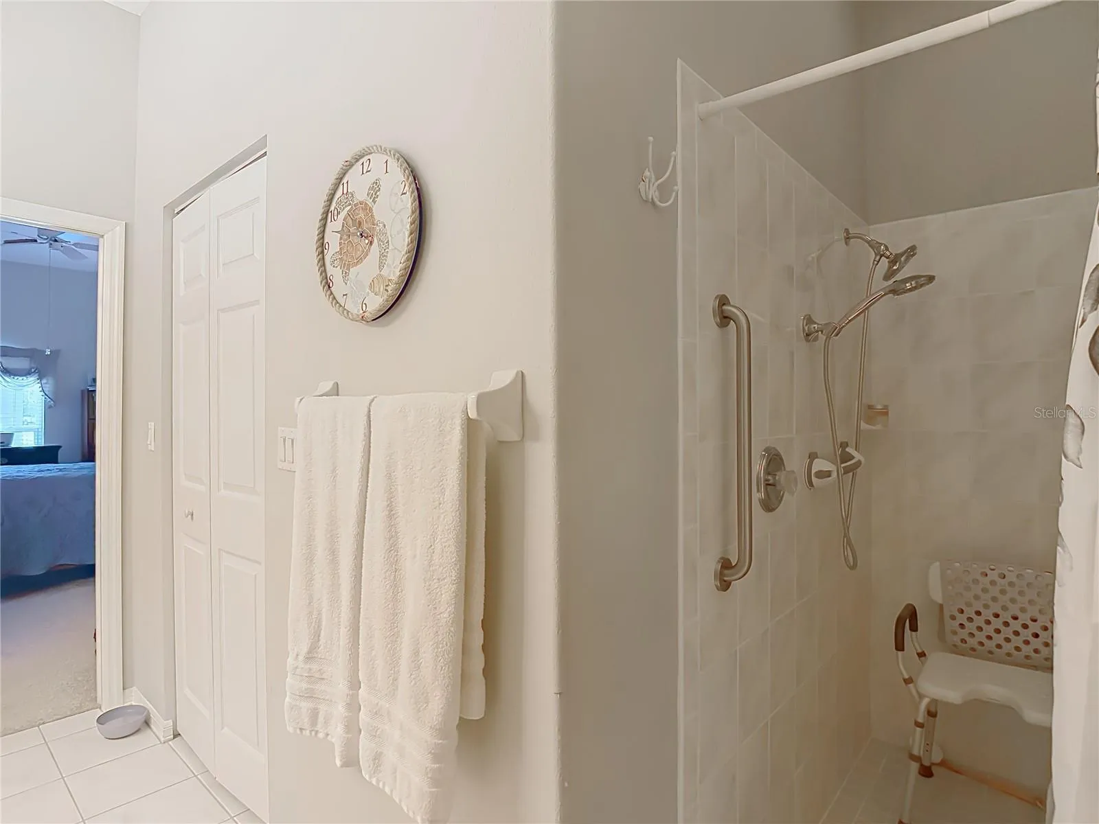 Walk in shower has a safety bar in place