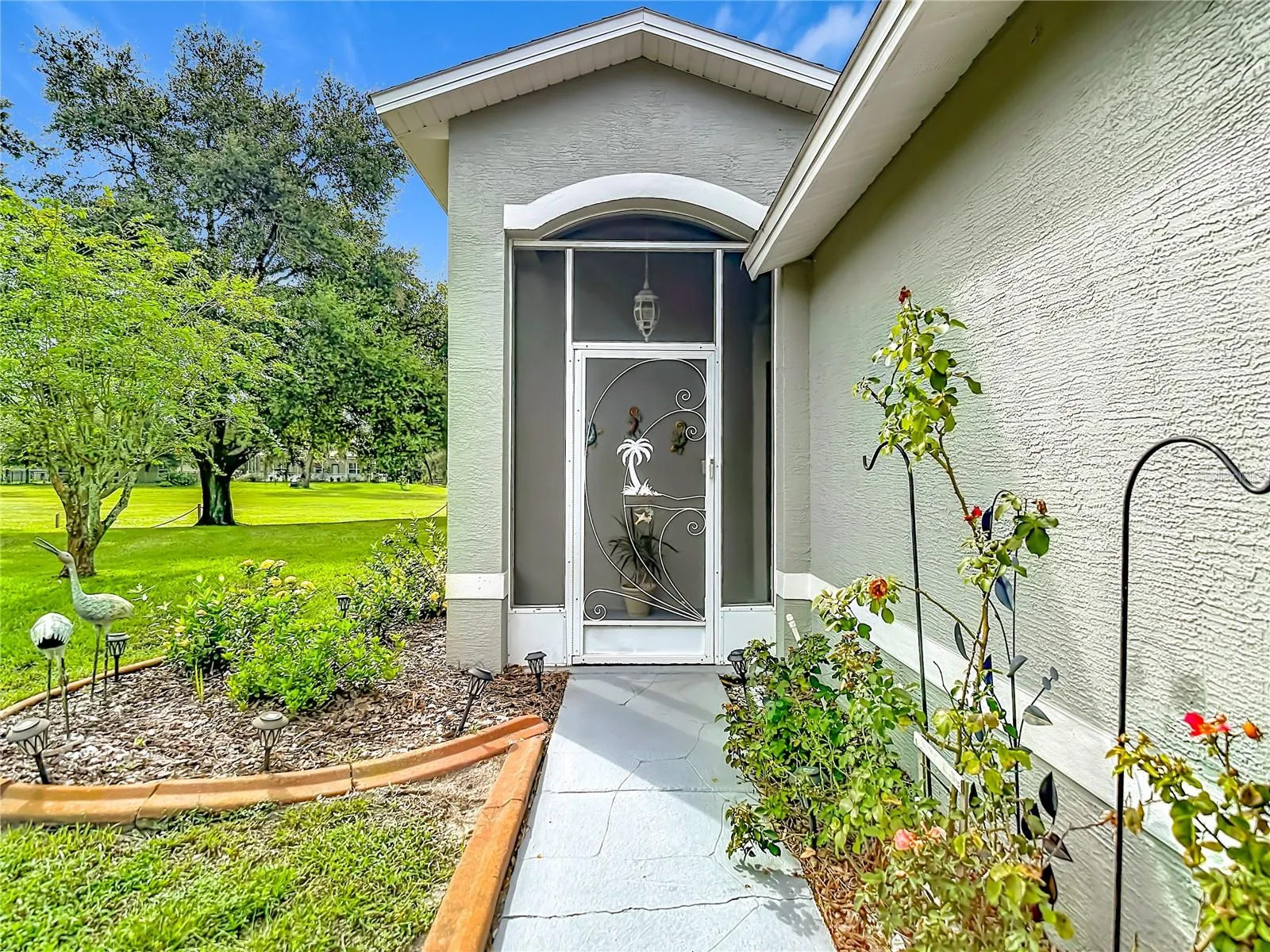 Entry way with cement sidewalk. The exterior painting of the building was done in 2023
