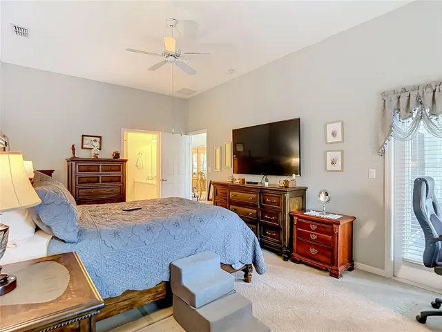 The primary bedroom sits on carpet and is located at the back of the villa. As you can see the room can accomdate quite a bit of bedroom furniture.
