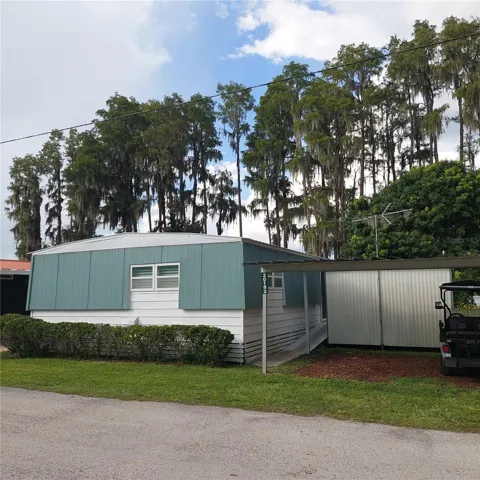 home has carport and large exterior shed, Ezgo golf cart (2022) included