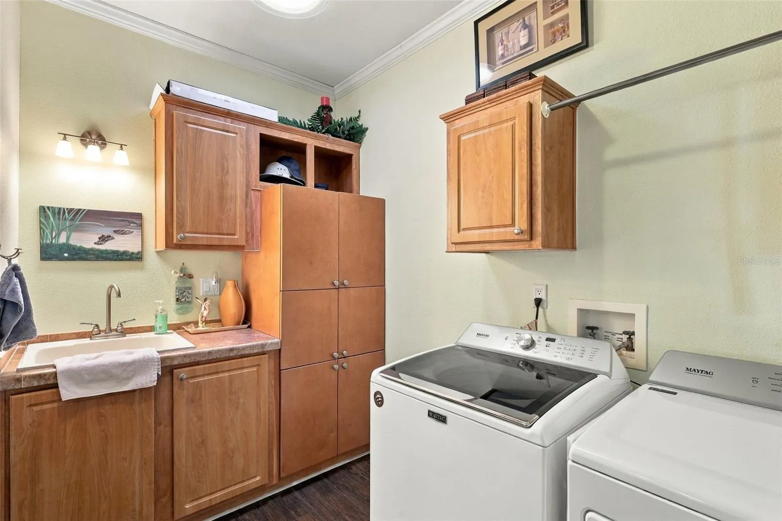The washer and dryer in this large laundry room stay with your new home.