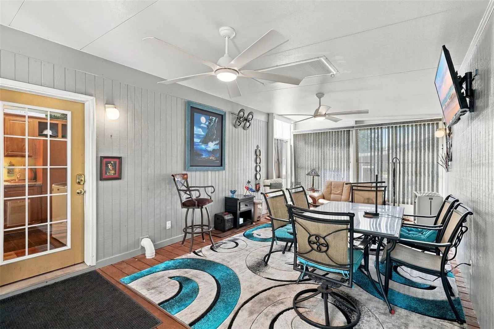 Florida room with screens &amp; vinyl windows towards rear deck entrance.