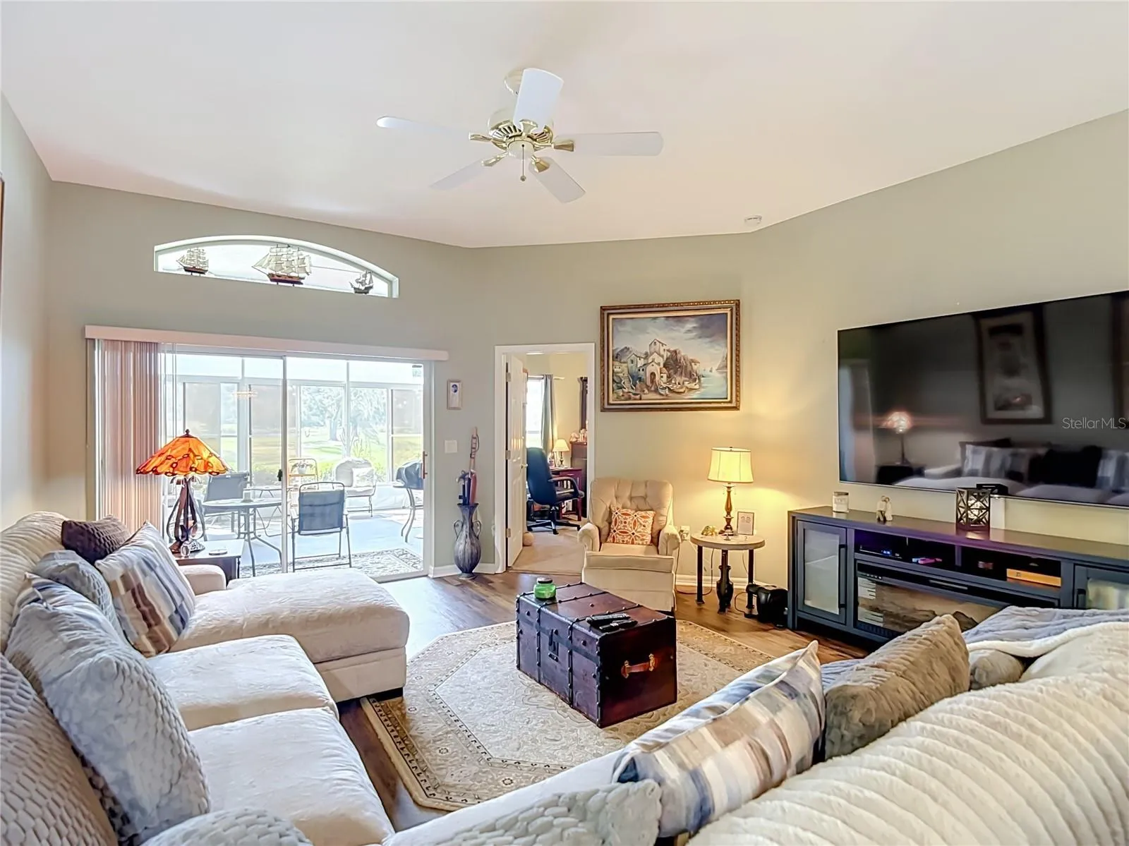 The living room is off the dining room and opens into the primary bedroom and patio ares. Room can accomodate oversized furniture with room to spare.