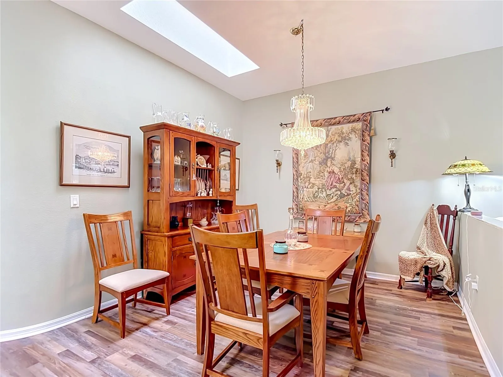 Plenty of space for at least six. Room for dining hutch as well. You also have a second skylight for that natural lighting.