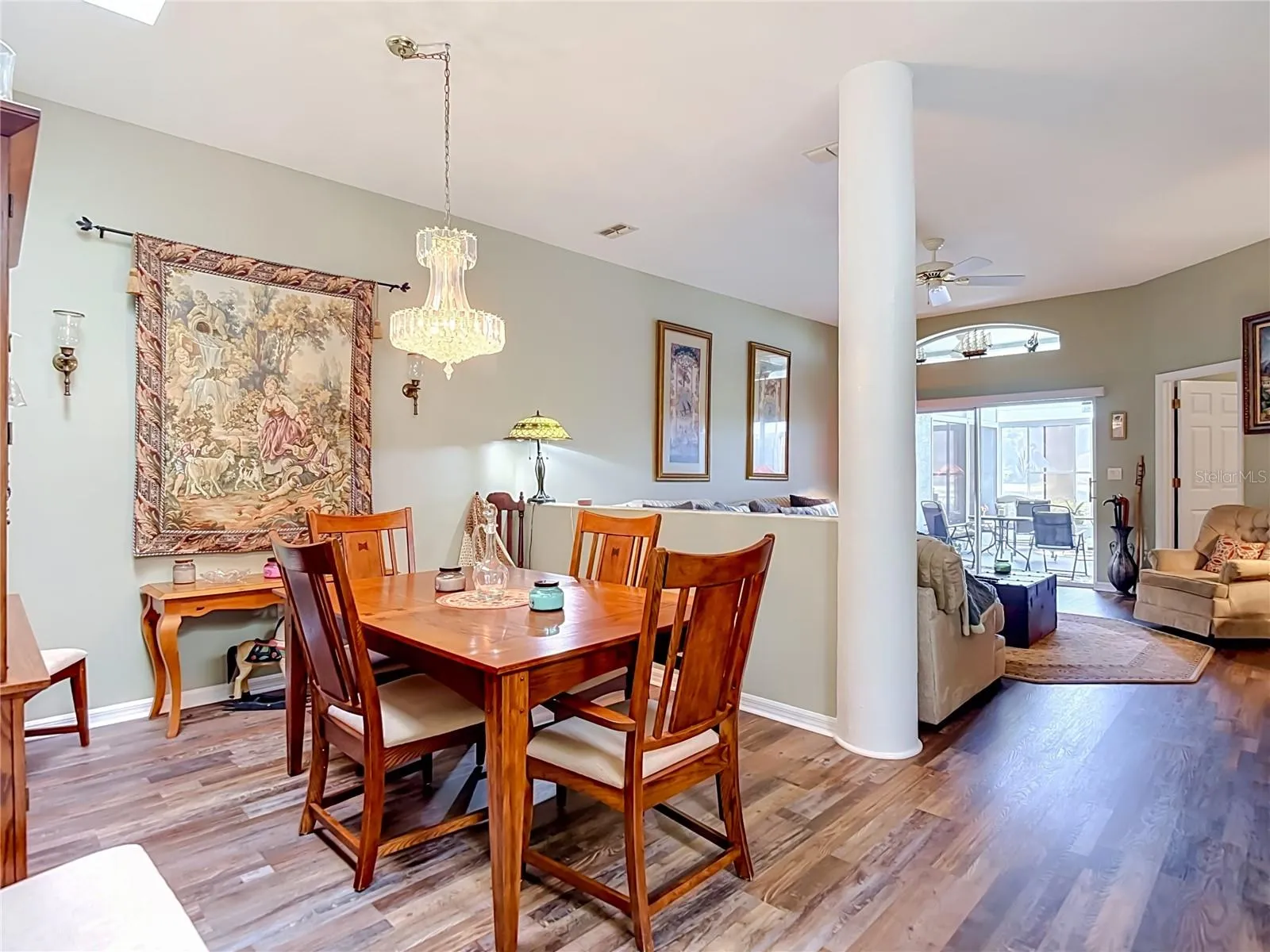 Dining area with a pillared post and divider from the living room for partial seperation of space.
