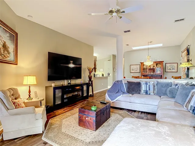 Looking from living room is the dining area and the kitchen. The high ceilings through out the home give it that big feeling.