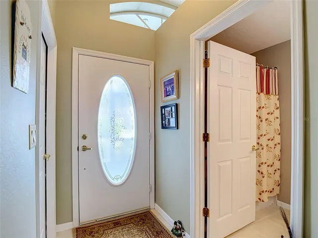 As you enter the open door is to bathroom 2. To the right is the door out to the garage.