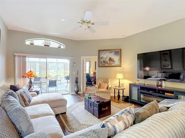 The living room is off the dining room and opens into the primary bedroom and patio ares. Room can accomodate oversized furniture with room to spare.