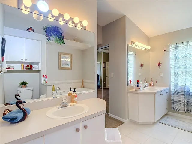 The primary bathroom has 2 seperate vanities with large mirrors to assist you with your personal needs with out banging into one another.