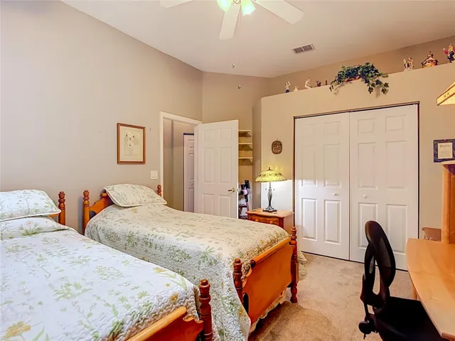 This room is presently set up as a guest room. Sits on carpet. The room has no exterior windows but does have a skylight for some natural lighting.