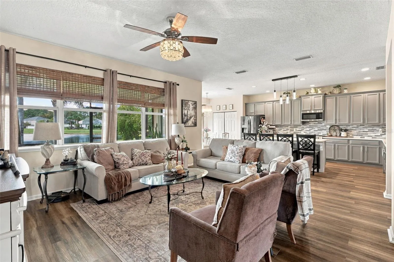 The kitchen opens to the spacious living room. Take a look at all those windows providing natural lighting throughout the home