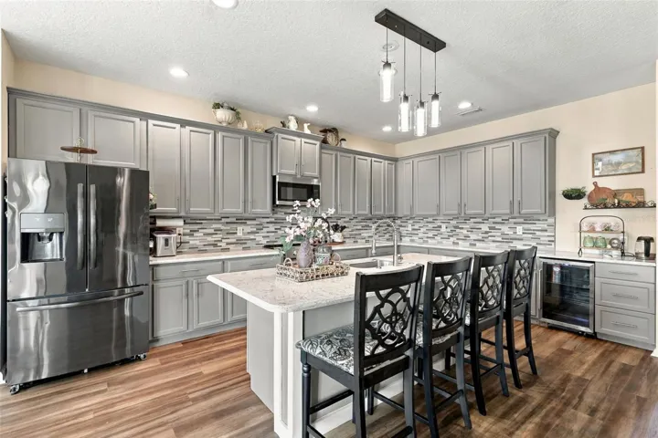 Look at this gorgeous updated kitchen with custom tile backsplash and quartz countertops.
