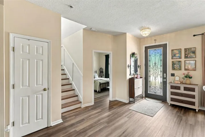 Front door afar, bonus room center, stairwell to 2nd floor left.