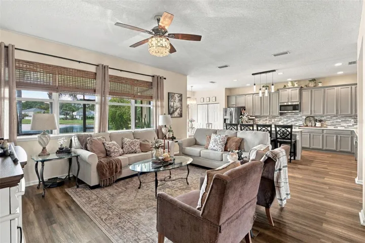 The kitchen opens to the spacious living room. Take a look at all those windows providing natural lighting throughout the home