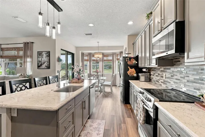 Stainless steel appliances convey and look at how much storage these 42" upper cabinetry offers!!