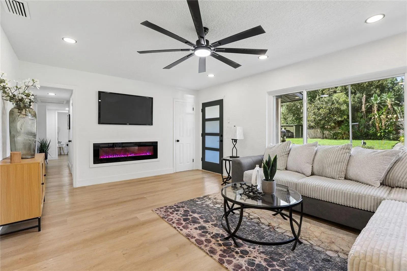Bright open-concept living with recessed lighting and modern finishes