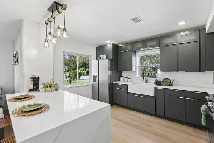 Waterfall-edge island with seating, storage and statement pendant lighting