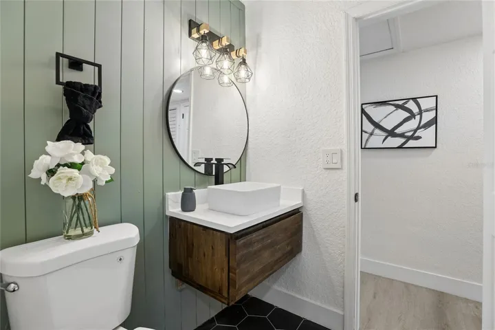 Beautifully redesigned second full bathroom with warm wood accents