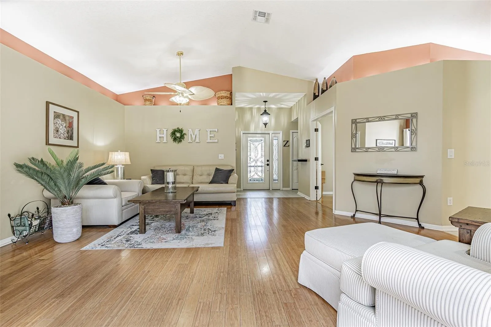 Cathedral ceilings, plant shelves and leaded glass entry door for a light, bright GREAT ROOM!