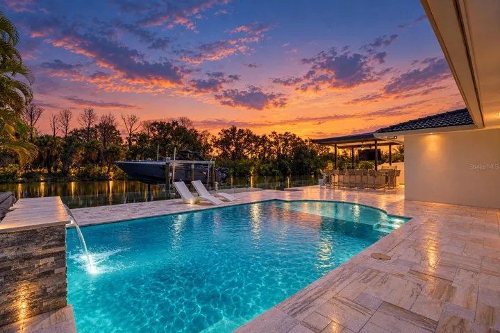 Saltwater pool with marble decking and outdoor kitchen